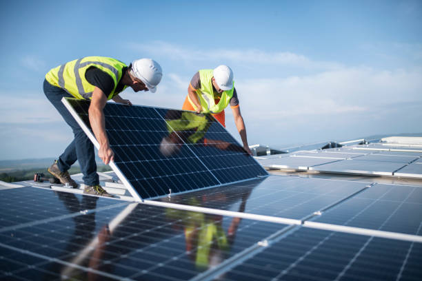 Technician inspecting solar panels in Gujarat, India, on a sunny day