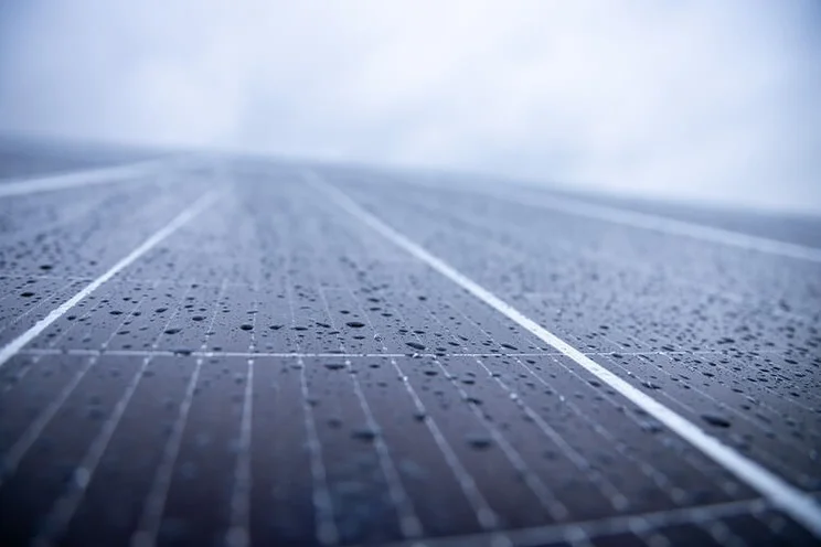 Solar panels under a cloudy sky