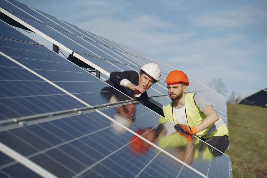 Technician inspecting solar panels for damage
